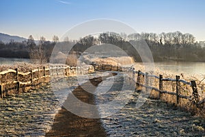 Beautiful vibrant English countryside lake image with frost and