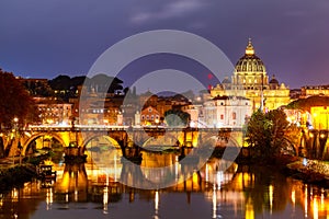 Beautiful vibrant night image of St. Peter\'s Basilica, Ponte Sant Angelo and Tiber River at dusk in Rome, Italy
