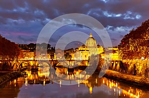 Beautiful vibrant night image of St. Peter\'s Basilica, Ponte Sant Angelo and Tiber River at dusk in Rome, Italy