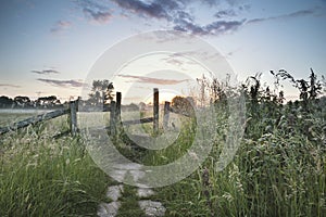 Beautiful vibrant Summer sunrise over English countryside landscape