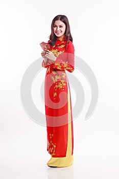 Beautiful Vietnamese woman with red ao dai holding red packet
