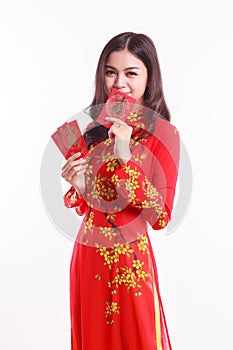 Beautiful Vietnamese woman with red ao dai holding red packet