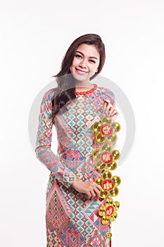 Beautiful Vietnamese woman wearing impression ao dai holding lucky decorate object