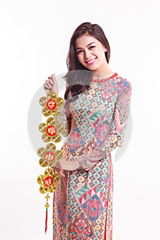 Beautiful Vietnamese woman wearing impression ao dai holding lucky decorate object