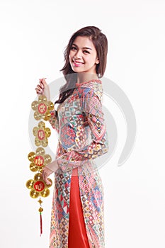 Beautiful Vietnamese woman wearing impression ao dai holding lucky decorate object