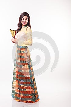 Beautiful Vietnamese young woman with modern style ao dai holding a paper fan