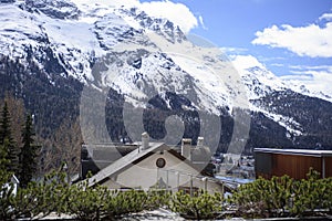 A beautiful view of the Alpine mountains and cottages of the resort town. St Moritz, Switzerland May 2023