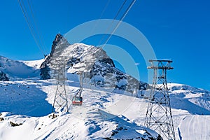 Beautiful view of Alps covered with snow and red cable car to Ma