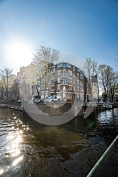 Beautiful view of Amsterdam canals with bridge and typical dutch houses. Holland