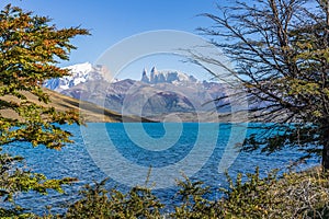 Beautiful view of aqua blue Laguna Azul with nature three tower mountains peak in clear blue sky in autumn, Torres del Paine