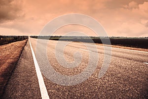 View of asphalt highway without transport. Orange tone