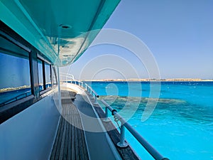 Beautiful view of the azure red sea and coral reef from the deck of a large white yacht. Hurghada, Egypt