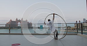 Beautiful view in the background of a man doing wheel gymnastics, 4k