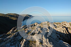 Beautiful view of Baikal Lake from the high cliffs of Cape Ulan-Zaba on a clear summer evening