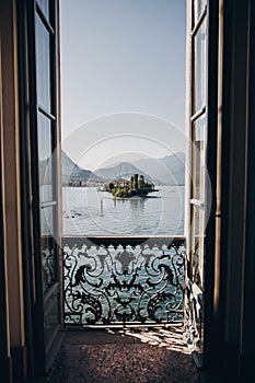 Beautiful view from balcony window at Lago Maggiore and Borromean Islands in sunny light, exploring Italy. Old architecture