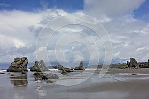 A beautiful view of Bandon beach in Bandon, Oregon, with the headlands and beautiful coast exposed at low tide for people to explo