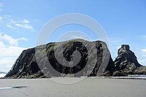 A beautiful view of Bandon beach in Bandon, Oregon, with the headlands and beautiful coast exposed at low tide for people to explo