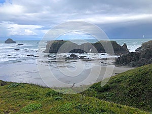 A beautiful view of Bandon beach in Bandon, Oregon, with the headlands and beautiful coast exposed at low tide for people to explo