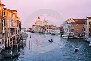 Beautiful view on Basilica di Santa Maria della Salute in golden evening light at sunset in Venice, Italy