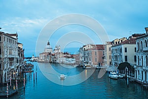 Beautiful view on Basilica di Santa Maria della Salute in golden evening light at sunset in Venice, Italy