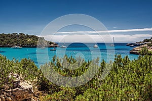 Beautiful view of the bay with turquoise water and yachts in Cala Mondrago National Park on Mallorca island, Spain.