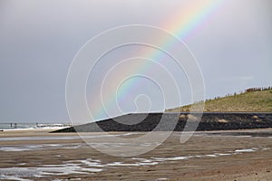 Beautiful view of a beach and a Rainbow in the sky in Vlissingen, The Netherlands