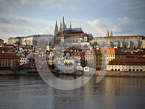 Beautiful view of beautiful Prague, the river Vltava and in the background is a castle with an interesting color