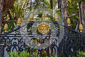 Beautiful view of black metal fence with gold decoration elements