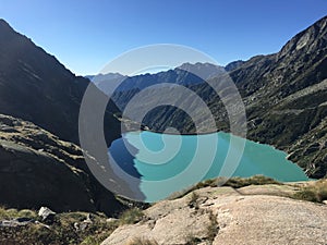 Beautiful view of blue alpine lake high in mountains with turquoise water