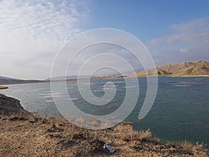 Beautiful view of blue lake and mountains with blue sky and white clouds