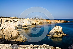 Beautiful view of the blue Mediterranean sea and the rock arch on a Sunny day from Cape Greco in Cyprus. Stone landscape of Ayia