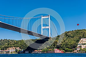 Beautiful view of Bosphorus bridge cross the Bosphorus strait with Turkish National flag, Istanbul, Turkey, view on a cruise ship