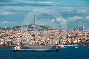 Beautiful view of bosphorus, Maiden Tower in Uskudar district and Camlica Tv tower in Camlica hill front of cloudy blue sky in photo