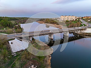 Beautiful view of the bridge across the Iset river in the city of Kamensk-Uralsky at sunset in spring. Kamensk-Uralskiy,