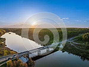 Beautiful view of the bridge across the Iset river in the city of Kamensk-Uralsky at sunset in spring. Kamensk-Uralskiy,