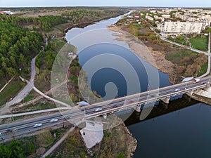 Beautiful view of the bridge across the Iset river in the city of Kamensk-Uralsky at sunset in spring. Kamensk-Uralskiy,