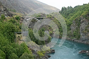 A beautiful view of the bridge across the turquoise river, consists of silt particles or glacial flour, which caused by glacier