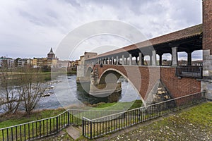 Beautiful view of bridge over Ticino river in Pavia at overcast day