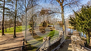 Beautiful view from a bridge of trees, a river, green grass and trails in the Proosdij Park