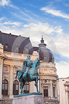 Beautiful view of the building of the Central University Library with equestrian monument to King Karol I in Bucharest, Romania