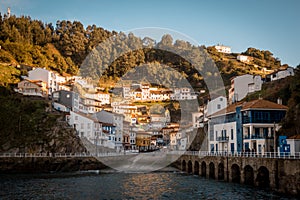 Beautiful view of the buildings of Cudillero, Asturies in Spain surrounded by hills photo