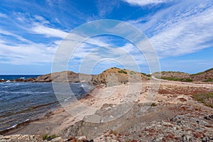 Beautiful view of the calm bay and the lighthouse in the distance on the island of Menorca, Balearic islands, Spain