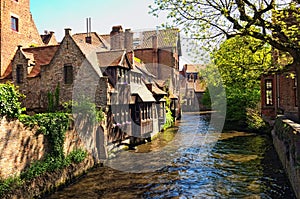 Beautiful view of the canal and traditional houses in the old town of Bruges dutch: Brugge, Belgium. Spring landscape photo