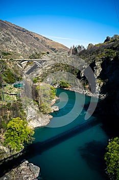 Beautiful view of a canyon with the bridge in the background taken on a sunny spring day in Kawarau Bridge, New Zealand