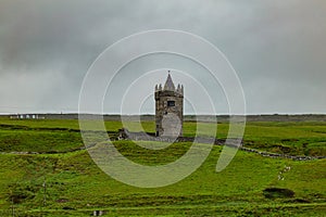 Beautiful view of the castle Doonagore, tower house in the Irish countryside in the village of Doolin