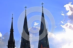Beautiful view of cathedral tops on sunny blue sky and white clouds backgroound. Uppsala, Sweden. Beautiful backgrounds.