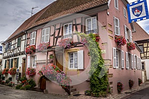 Beautiful view of charming street scene with colorful houses in the historic town of Eguisheim on an idyllic sunny day with blue