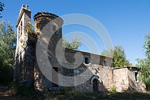 Beautiful view of a church with a stone round tower at Merindades, Burgos, Spain. Blue sky