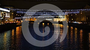 Beautiful view of city canal with evening lights. Concept. Yellow city lights illuminating the streets by canal