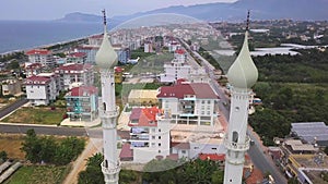 Beautiful view of the city. Clip. A mosque with domes next to houses and in the background the sea and mountains and